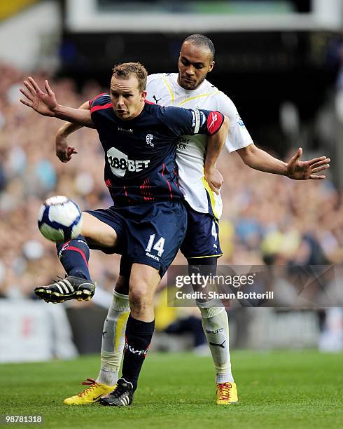 Kevin Davies of Bolton Wanderers is challenged by Younes Kaboul during the Barclays Premier League match between Tottenham Hotspur and Bolton...