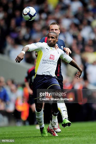 Jermain Defoe of Tottenham Hotspur is challeged by Matt Taylor of Bolton Wanderers during the Barclays Premier League match between Tottenham Hotspur...
