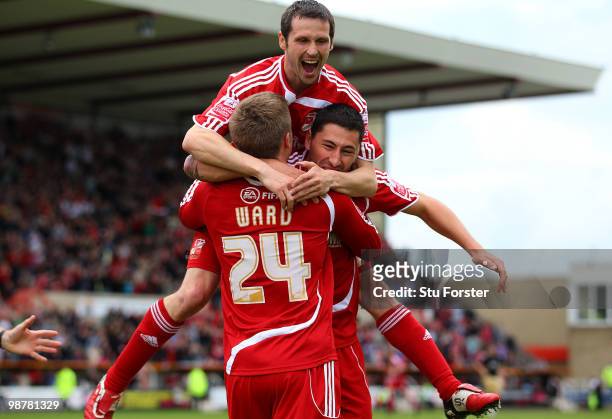 Swindon Town forward Billy Paynter celebrates the first goal with Craig Easton and Danny Ward during the Coca Cola League One match between Swindon...