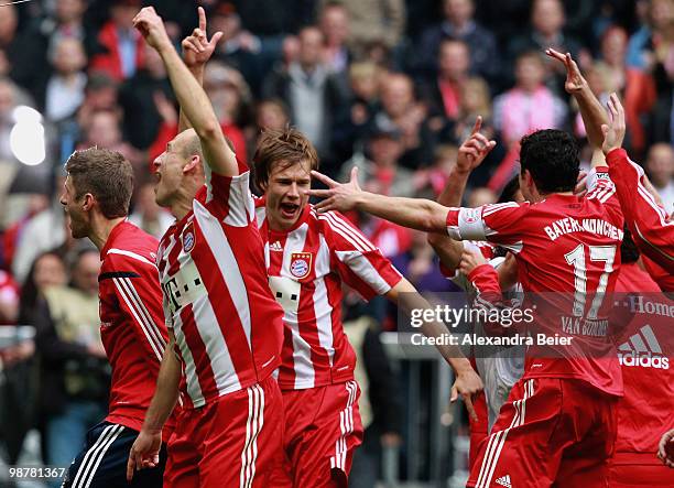 Thomas Mueller, Arjen Robben, Holger Badstuber and Mark van Bommel of Bayern Muenchen celebrate their 3-1 victory after the Bundesliga match between...