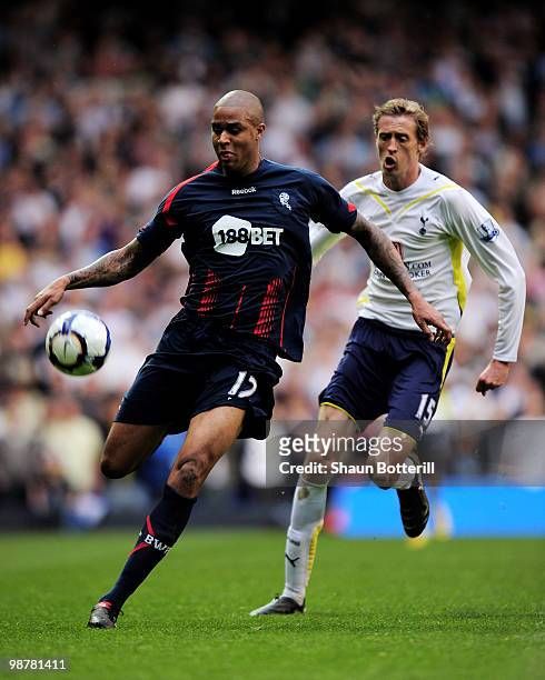 Zat Knight of Bolton Wanderers is challenged Peter Crouch of Tottenham Hotspur during the Barclays Premier League match between Tottenham Hotspur and...