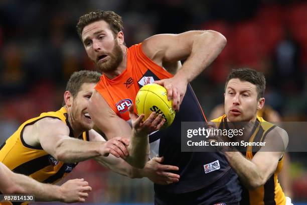 Dawson Simpson of the Giants is tackled during the round 15 AFL match between the Greater Western Sydney Giants and the Hawthorn Hawks at Spotless...