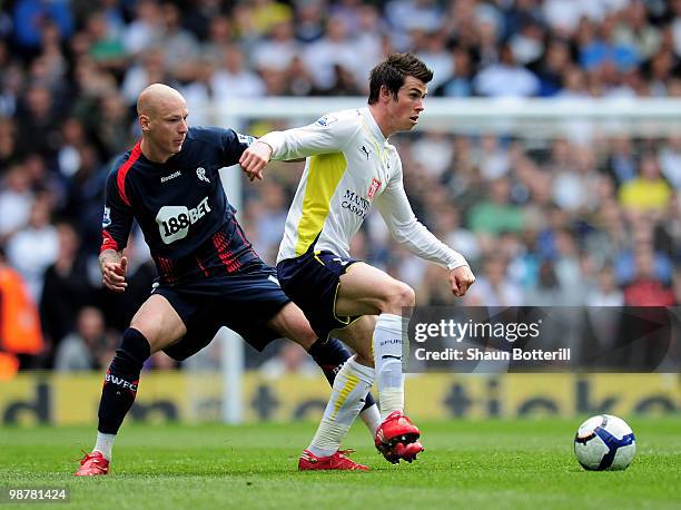 Gareth Bale of Tottenham Hotspur is challeged by Gretar Steinsson of Bolton Wanderers during the Barclays Premier League match between Tottenham...