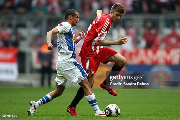 Thomas Mueller of Bayern is tackled by Mimoun Azaouagh of Bochum during the Bundesliga match between FC Bayern Muenchen and VfL Bochum at Allianz...