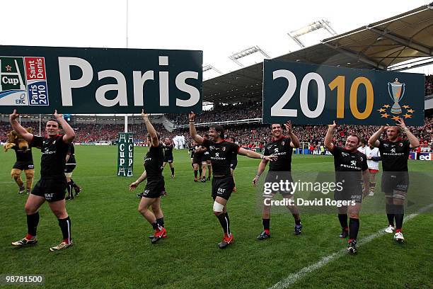 Toulouse players display advertising the venue of the Heineken Cup Final after their victory during the Heineken Cup semi final match between...