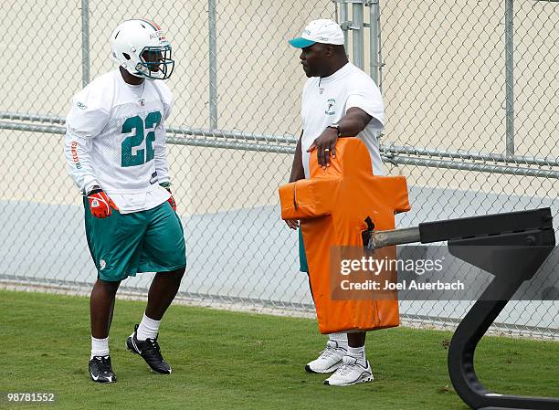 Running backs coach James Saxon works with James Aldridge of the Miami Dolphins on blocking drills during the rookie mini camp May 1, 2010 at the...