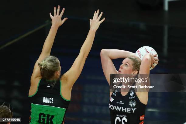 Caitlin Thwaites of the Magpies shoots as Courtney Bruce of the Fever defends during the round nine Super Netball match between the Magpies and the...