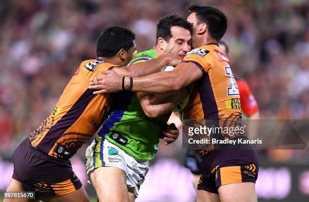 Michael Oldfield of the Raiders takes on the defence during the round 16 NRL match between the Brisbane Broncos and the Canberra Raiders at Suncorp...