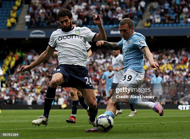 Craig Bellamy of Manchester City attempts to cross the ball past Carlos Cuellar of Aston Villa during the Barclays Premier League match between...