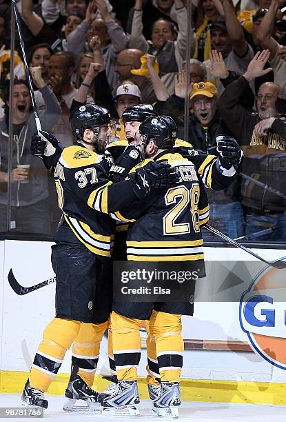 Steve Begin of the Boston Bruins celebrates his goal with teammates Patrice Bergeron and Mark Recchi in the first period against the Philadelphia...