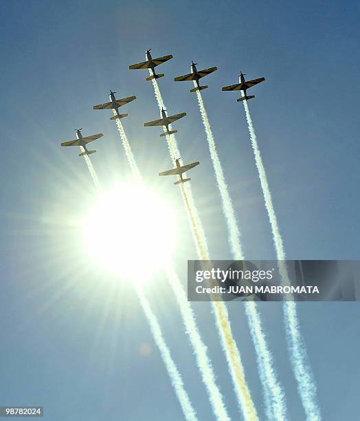 Seven Embraer EMB 312 Tucano aircrafts of the Brazilian Air Force's "Esquadrilha da Fumaça" fly in arrow formation over 9 de Julio avenue in Buenos...