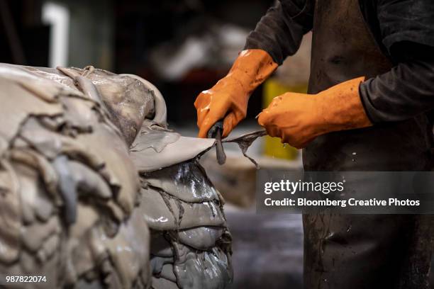 a worker trims horsehides at a leather tannery - leather industry stock pictures, royalty-free photos & images