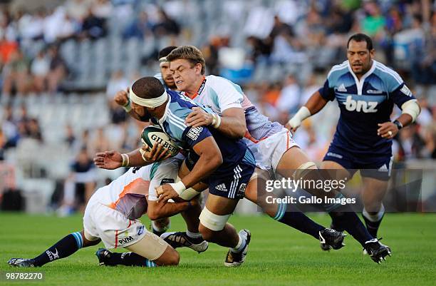 Viliame Maafu of the Blues is tackled by Juan Smith of the Cheetahs during the Super 14 Round 12 match between Vodacom Cheetahs and Blues at Vodacom...