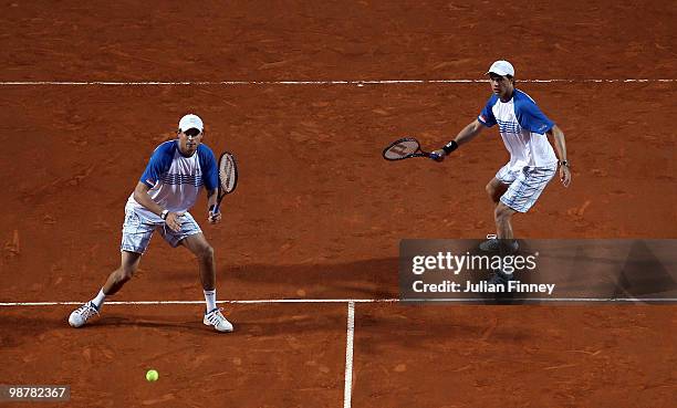 Bob and Mike Bryan of USA in action in their match against Lukasz Kubot of Poland and Oliver Marach of Austria in the doubles during day seven of the...