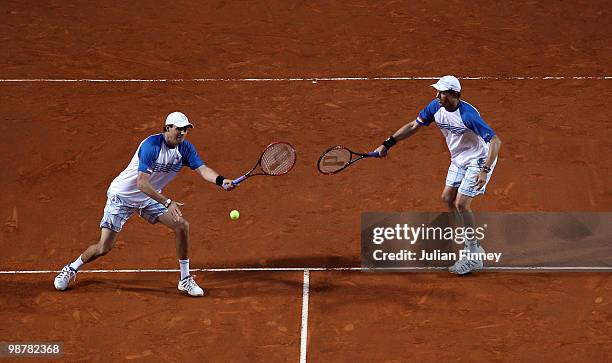 Bob and Mike Bryan of USA in action in their match against Lukasz Kubot of Poland and Oliver Marach of Austria in the doubles during day seven of the...