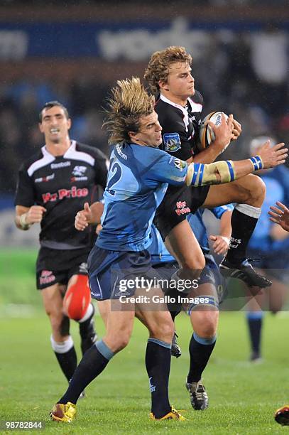 Wynand Olivier of the Bulls tackles Patrick Lambie of the Sharks during the Super 14 Round 12 match between the Vodacom Blue Bulls and the Sharks at...