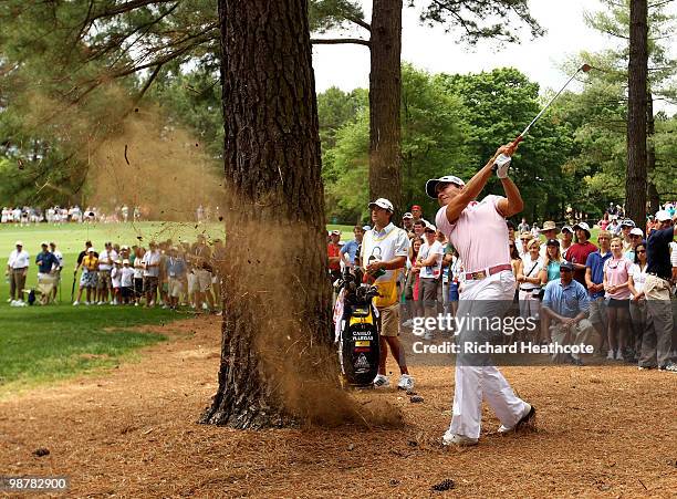 Camilo Villegas of Colombia plays from behind a tree trunk on the 5th during the third round of the Quail Hollow Championship at Quail Hollow Country...