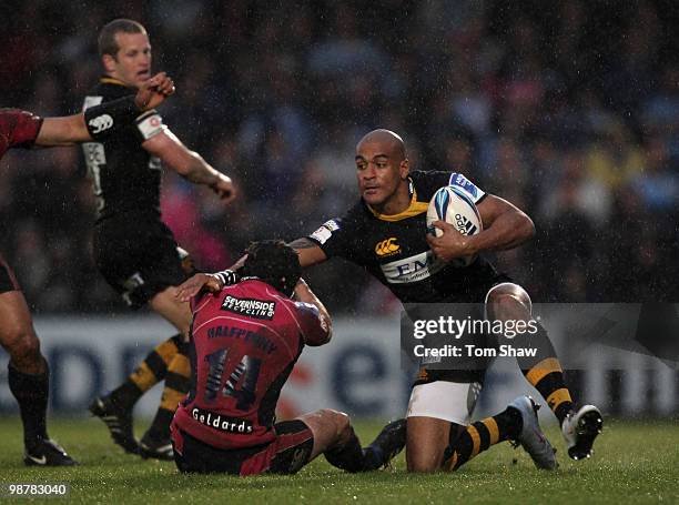 Tom Varndell of Wasps evades a tackle from Leigh Halfpenny of Cardiff during the Amlin Challenge Cup Semi Final match between London Wasps and...