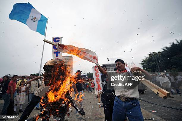 Trade unionists burn an effigy representing the President of Guatemala Alvaro Colom on May 1 during the commemoration of May Day in Guatemala City....