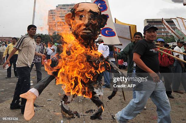 Unionists burn an effigy representing the president of Guatemla Alvaro Colom on May 1 during a march by the Internacional Labour Day in Guatemala...