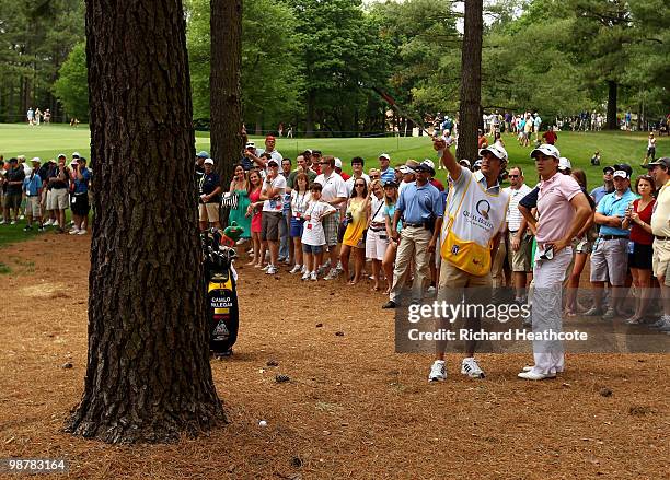 Camilo Villegas of Colombia looks at his options as his ball lies behind a tree trunk on the 5th during the third round of the Quail Hollow...