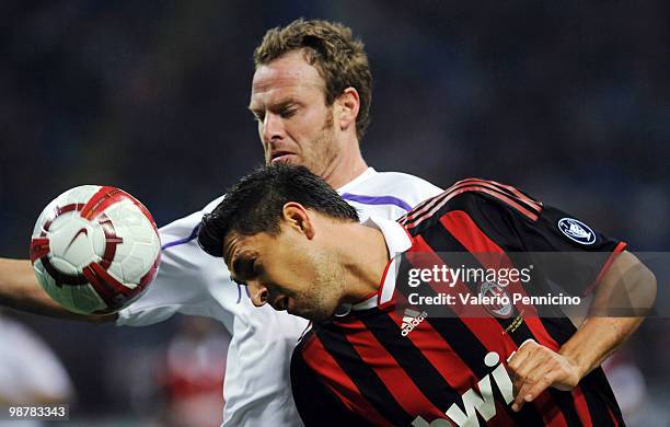 Marco Borriello of AC Milan battles for the ball with Cesare Natali of ACF Fiorentina during the Serie A match between AC Milan and ACF Fiorentina at...