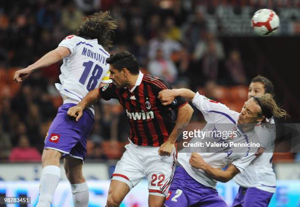 Marco Borriello of AC Milan is challenged by Riccardo Montolivo and Per Billeskov Kroldrup of ACF Fiorentina during the Serie A match between AC...