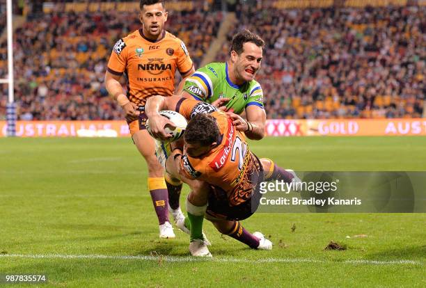 Corey Oates of the Broncos scores a try during the round 16 NRL match between the Brisbane Broncos and the Canberra Raiders at Suncorp Stadium on...