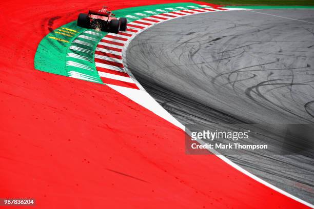Sparks fly behind Sebastian Vettel of Germany driving the Scuderia Ferrari SF71H on track during final practice for the Formula One Grand Prix of...