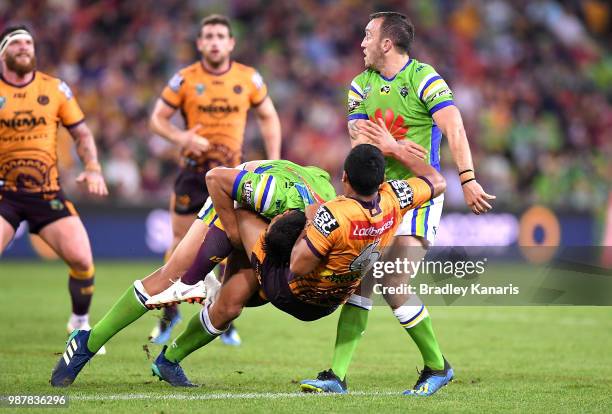 Anthony Milford of the Broncos is picked up in the tackle during the round 16 NRL match between the Brisbane Broncos and the Canberra Raiders at...