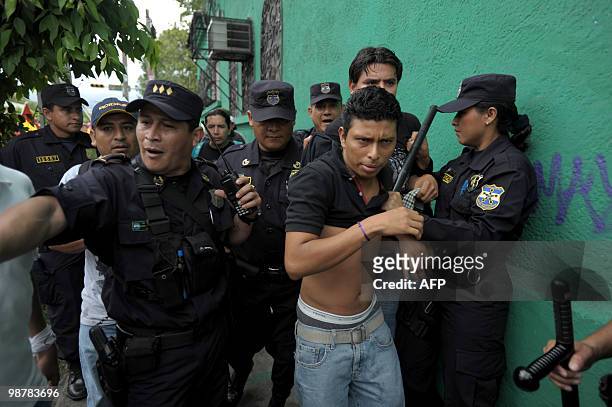 Salvadorean police arrest a demonstratorr during the May Day march 1, 2010 in San Salvador. AFP PHOTO/ Jose CABEZAS