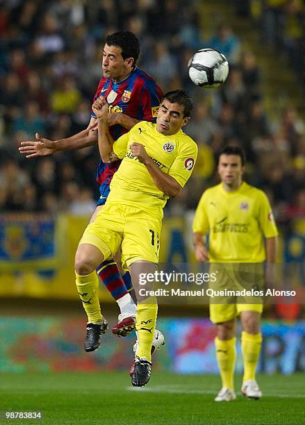 Sergio Busquets of FC Barcelona competes for the ball with Ibagaza of Villarreal CF during the La Liga match between Villarreal CF and FC Barcelona...