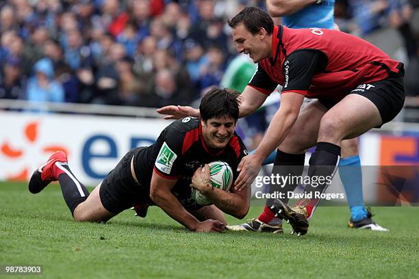 David Skrela of Toulouse is congratulated by team mate Louis Picamoles after scoring the second try during the Heineken Cup semi final match between...