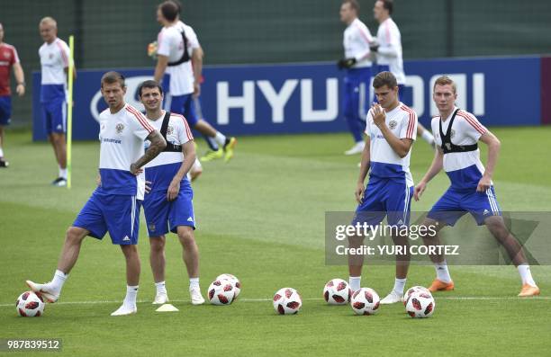 Russia's forward Fedor Smolov, Russia's midfielder Alan Dzagoev, Russia's midfielder Roman Zobnin and Russia's defender Andrey Semenov attend a...