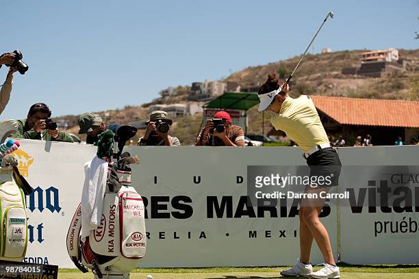 Photographers shoot as Michelle Wie takes a practice swing during the third round of the Tres Marias Championship at the Tres Marias Country Club on...