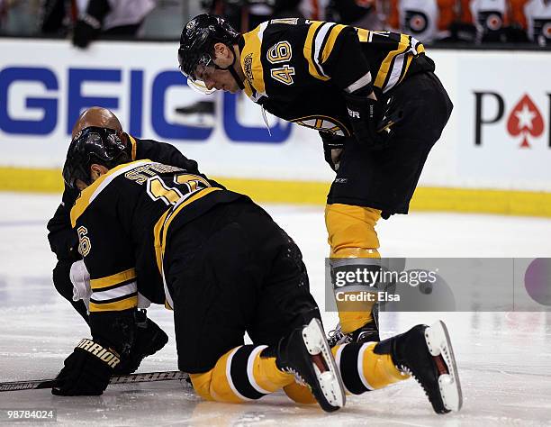 David Krejci of the Boston Bruins watches as teammate Marco Sturm is attended to after a hit in the first period against the Philadelphia Flyers in...