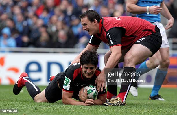 David Skrela of Toulouse is congratulated by team mate Louis Picamoles after scoring the second try during the Heineken Cup semi final match between...