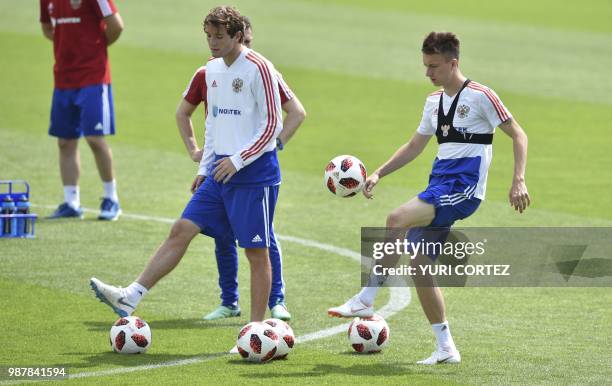 Russia's defender Mario Fernandes and teammate defender Andrey Semyonov attend a training session in Novogorsk, outside Moscow, on June 30 during the...