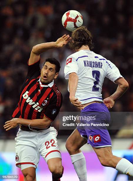 Marco Borriello of AC Milan clashes with Per Billeskov Kroldrup of ACF Fiorentina during the Serie A match between AC Milan and ACF Fiorentina at...