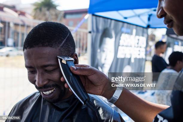 Youth has his haircut as part of the centenary celebrations of the birth of South Africa's first black leader Nelson Mandela following the theme 'Be...