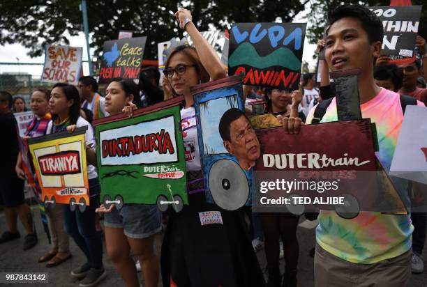 Activists holding anti-President Rodrigo Duterte's placards join thousands of members of Lesbian Gay Bisexual Transgender/Transexual Queer hold a...