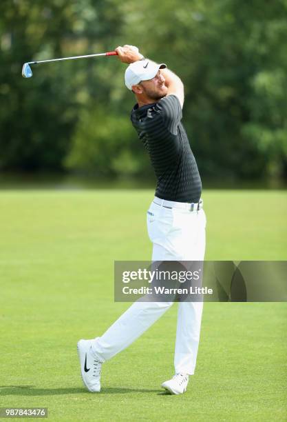 Chris Wood of England plays his second shot on the 1st hole during day three of the HNA Open de France at Le Golf National on June 30, 2018 in Paris,...