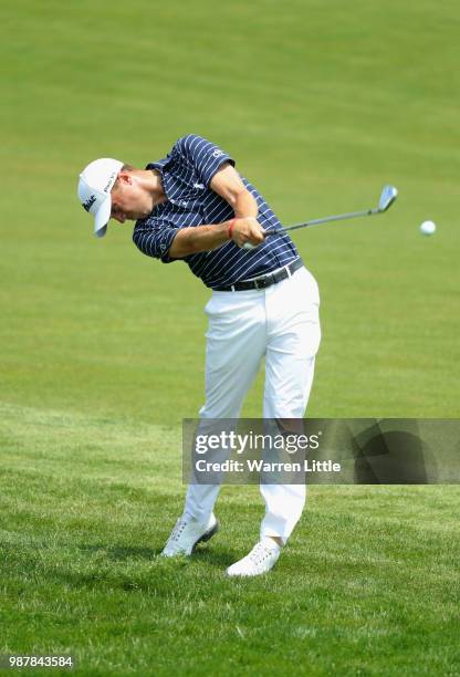 Justin Thomas of the United States plays his second shot on the 1st hole during day three of the HNA Open de France at Le Golf National on June 30,...