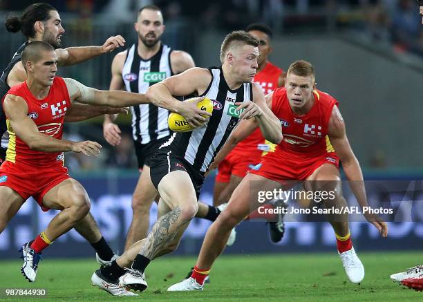 Jordan De Goey of the Magpies runs with the ball during the round 15 AFL match between the Gold Coast Suns and the Collingwood Magpies at Metricon...