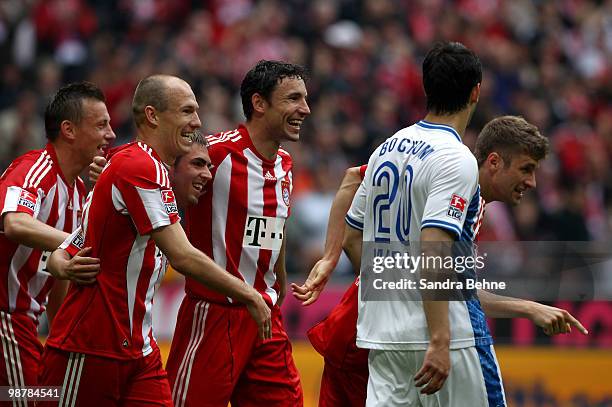 Thomas Mueller of Bayern celebrates with team mates after scoring the second goal during the Bundesliga match between FC Bayern Muenchen and VfL...