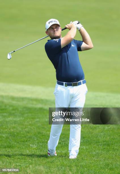 Tyrrell Hatton of England plays his second shot on the 1st hole during day three of the HNA Open de France at Le Golf National on June 30, 2018 in...