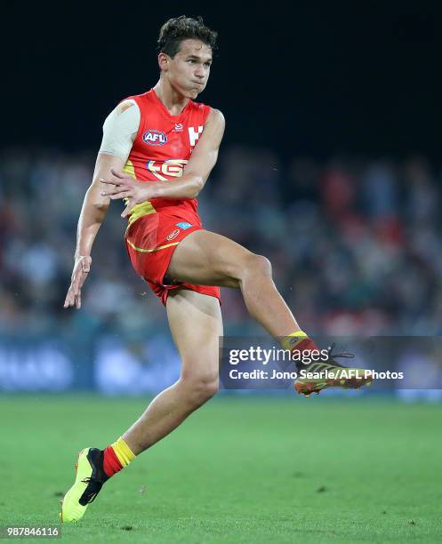 Wil Powell of the Suns kicks the ball during the round 15 AFL match between the Gold Coast Suns and the Collingwood Magpies at Metricon Stadium on...