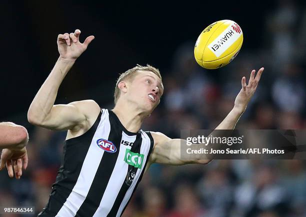 Jaidyn Stephenson of the Magpies marks the ball during the round 15 AFL match between the Gold Coast Suns and the Collingwood Magpies at Metricon...