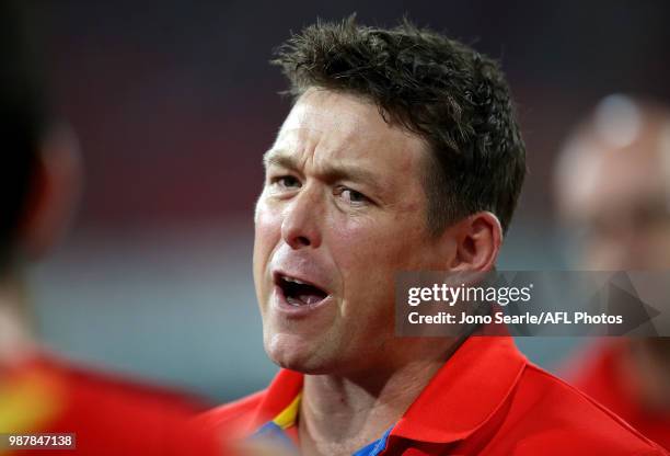 Stuart Dew, Senior Coach of the Suns talks to his team during the round 15 AFL match between the Gold Coast Suns and the Collingwood Magpies at...