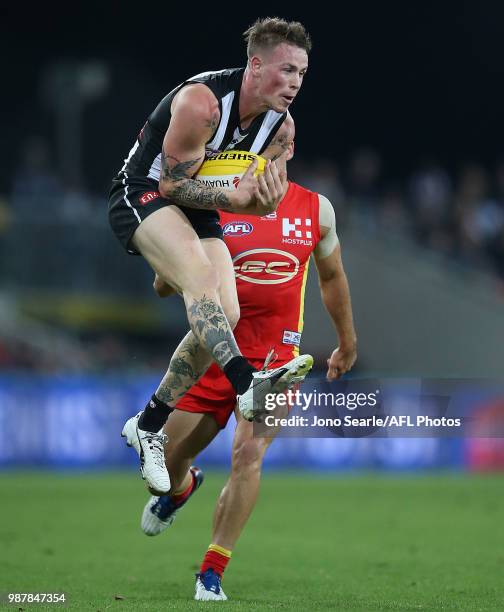 Ben Crocker of tghe Magpies catches the ball during the round 15 AFL match between the Gold Coast Suns and the Collingwood Magpies at Metricon...